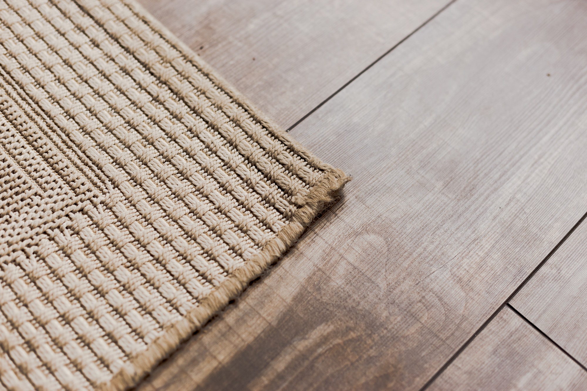 Laminate parquete floor with beige soft carpet