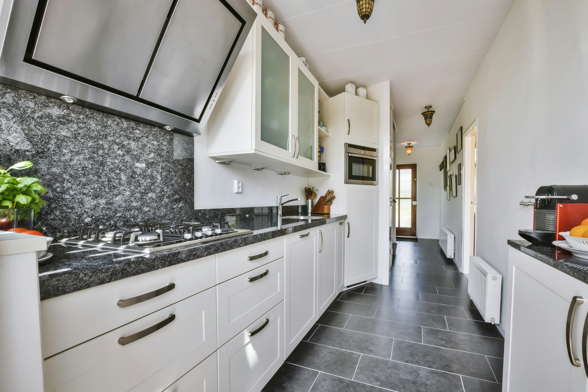 Lovely narrow and long kitchen with black floor